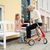 Red byACRE Ultralight Rollator with Lady in the seat